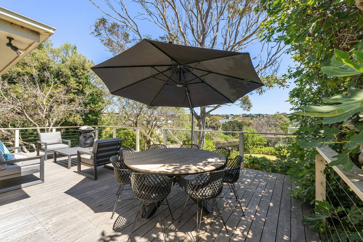 Close-up of sturdy patio cantilever umbrella with base on wooden deck