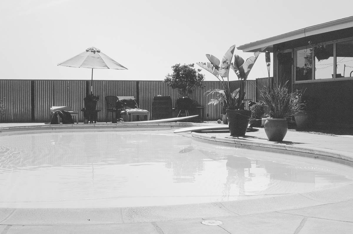large patio umbrellas cantilever installed over modern patio seating area with offset frame and full canopy coverage