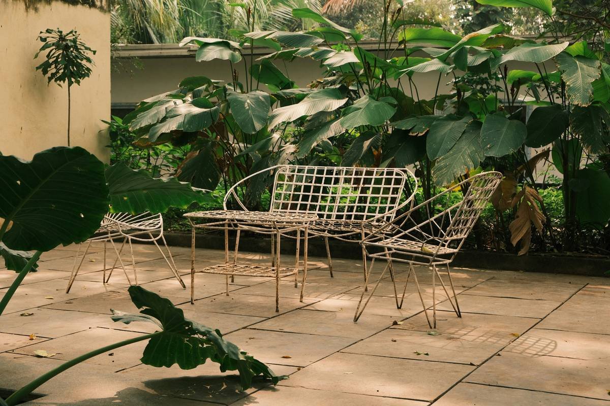 cantilever umbrella vs patio umbrella comparison showing side-by-side setups on a wooden deck with dining sets